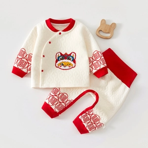 Close-up of baby padded pajamas with festive lion embroidery and high-waisted pants