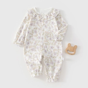 Detail of floral baby romper with ruffled collar and soft cotton long sleeves