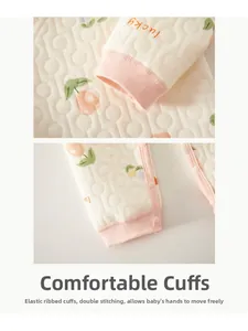 Detail of baby quilted cotton pajama with elastic pink ribbed cuffs and tulip print