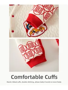Detailed view of quilted cotton baby suit featuring festive lion embroidery and Fu patterns