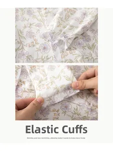 Detail of elastic cuffs on baby floral romper showing stretchable cotton fabric texture