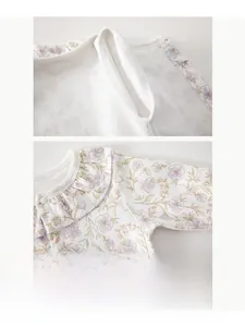 Detail of boneless stitching and snap buttons on white floral baby bodysuit