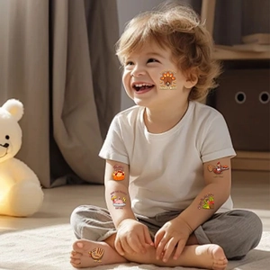 Detail of Thanksgiving temporary tattoos with cartoon turkey and pumpkin on child skin