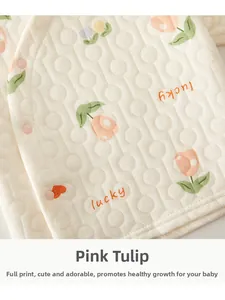 Detail of baby quilted top featuring pink tulip print and soft textured fabric