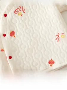 Detail of baby quilted top featuring traditional red lantern print and Fu character