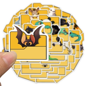 Close-up of a hand holding a yellow waterproof PVC cartoon animal folder sticker