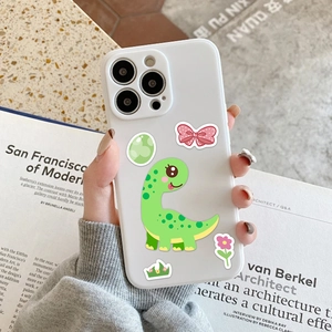 Handheld view of a white phone case with cute cartoon dinosaur and floral stickers
