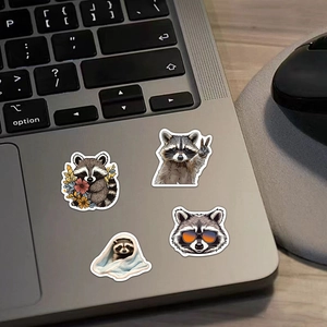 Cute raccoon cartoon stickers set on a silver laptop for waterproof DIY decoration