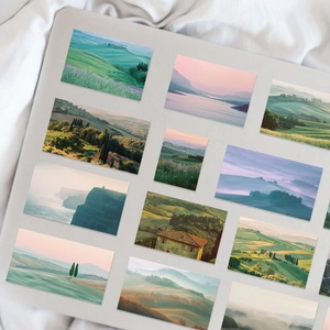Detail of artistic landscape photography stickers on a grey laptop with scenic views