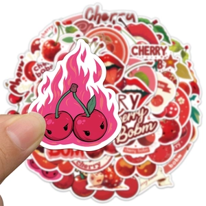 Close-up of waterproof PVC cherry stickers with creative graffiti designs and white borders