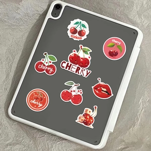 Pack of assorted cartoon cherry PVC stickers displayed on a tablet case background