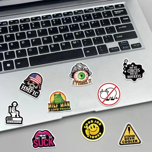 Detailed view of waterproof safety helmet stickers applied on a laptop surface