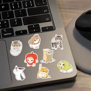 8-piece set of creative waterproof cartoon cat stickers on a silver laptop palm rest