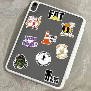 Detail showing creative waterproof stickers with humorous slogans on a grey tablet