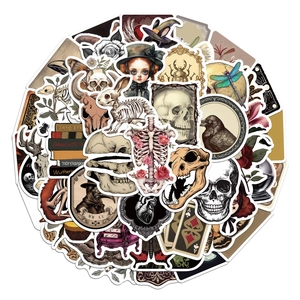 Macro shot of vintage dark academia stickers featuring ravens and anatomical illustrations