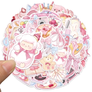 Close-up of a pink cartoon sheep sticker held by hand from a decorative sticker set