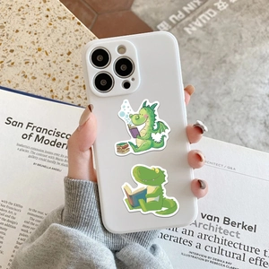 White iPhone case featuring cute cartoon reading dragons on a cozy bookish background