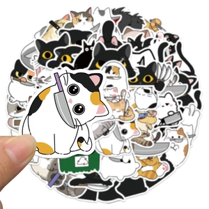 Macro detail of waterproof cartoon cat meme stickers for DIY laptops and luggage decor