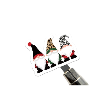 Close-up of cute Christmas gnome stickers with leopard print hats and plaid shirts