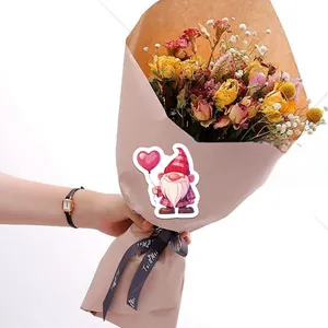 Cartoon gnome sticker with red plaid hat and pink heart balloon on dried flower bouquet