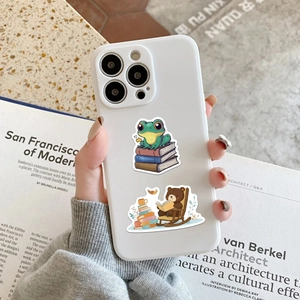 Detailed view of cute cartoon animal stickers on a white phone case for book lovers