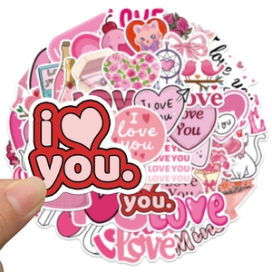 Close-up of pink Valentine cartoon stickers set with hearts and cats for laptops