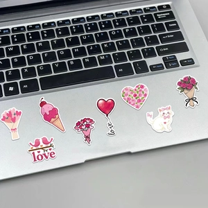 Detailed stickers with heart balloons and rose patterns on a laptop for Valentine's Day