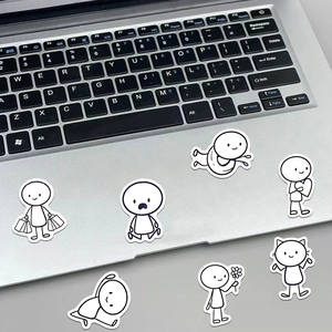 Close-up of cute cartoon stick figure stickers on a grey laptop palm rest area