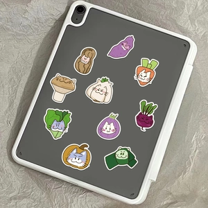 Cartoon cat vegetable stickers displayed on a tablet back with textured background