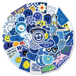 Close-up of Klein blue graffiti stickers with smiley faces and flowers for decor