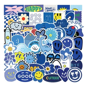 Close-up of blue doodle stickers with happy faces and graffiti art for laptops