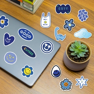 59Pcs blue smiley doodle stickers for laptop and luggage decoration on wooden desk