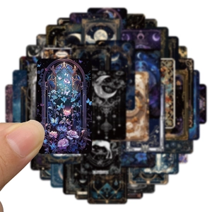 Close-up of gothic fantasy stickers featuring starry sky and moon in dark blue tones