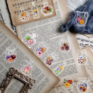 Macro shot of PET transparent vintage floral stickers in glass bottles for scrapbooking