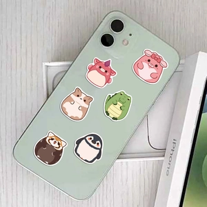 Detailed macro view of cute animal stickers applied to the back of a light green phone case