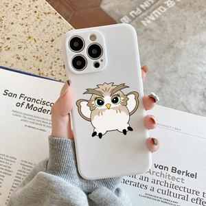 Cute cartoon owl silicone phone case for iPhone Pro models held over a magazine