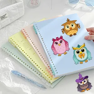Detail of macaron color spiral notebooks with functional planner pages and owl illustration