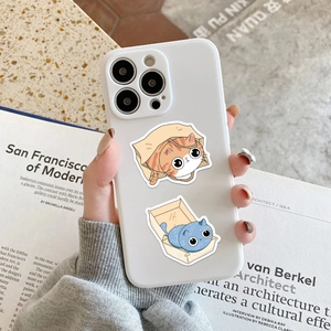 Close-up of white iPhone case featuring cute cartoon cats in boxes and paper bags