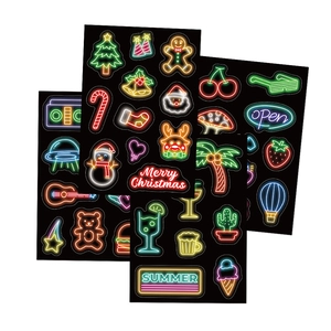 Neon style stickers set featuring Christmas and summer themes on black background