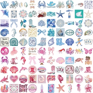 Flat lay of pink and blue coastal cowgirl stickers featuring shells and cowboy boots