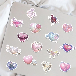 Detail of Y2K heart stickers with metallic rose and pearl textures on a laptop cover