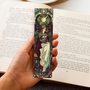 Stained glass art bookmarks featuring fantasy characters placed on an open vintage book