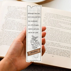 Vintage paper bookmark with floral illustration and motivational text on an open book