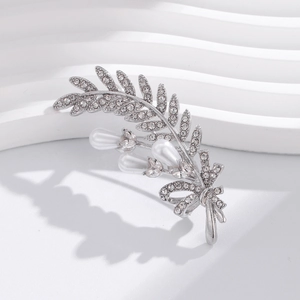 Détails d'une broche épi de blé argentée avec strass scintillants et perles blanches