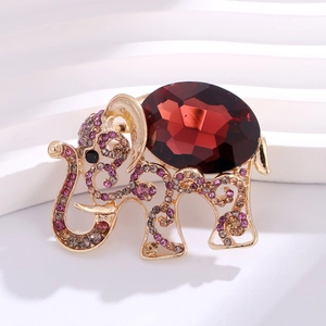 Elegant elephant brooch in gold metal with red gemstone and colorful rhinestones
