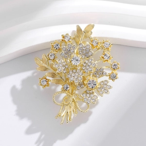 Detailed view of elegant gold flower bouquet brooch with sparkling rhinestone accents