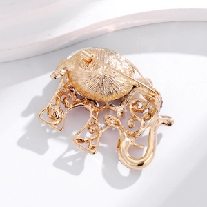 Exquisite gold elephant brooch featuring a detailed back structure and safety pin clasp