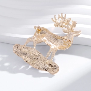 Back view of a gold reindeer brooch showing the brushed metal texture and safety pin clasp