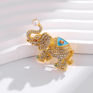 Exquisite elephant brooch with sparkling rhinestones and blue enamel on a gold base