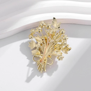 Elegant gold-tone bouquet brooch with star accents and secure safety pin closure